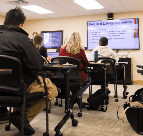 A classroom full of realtors receiving continuing education